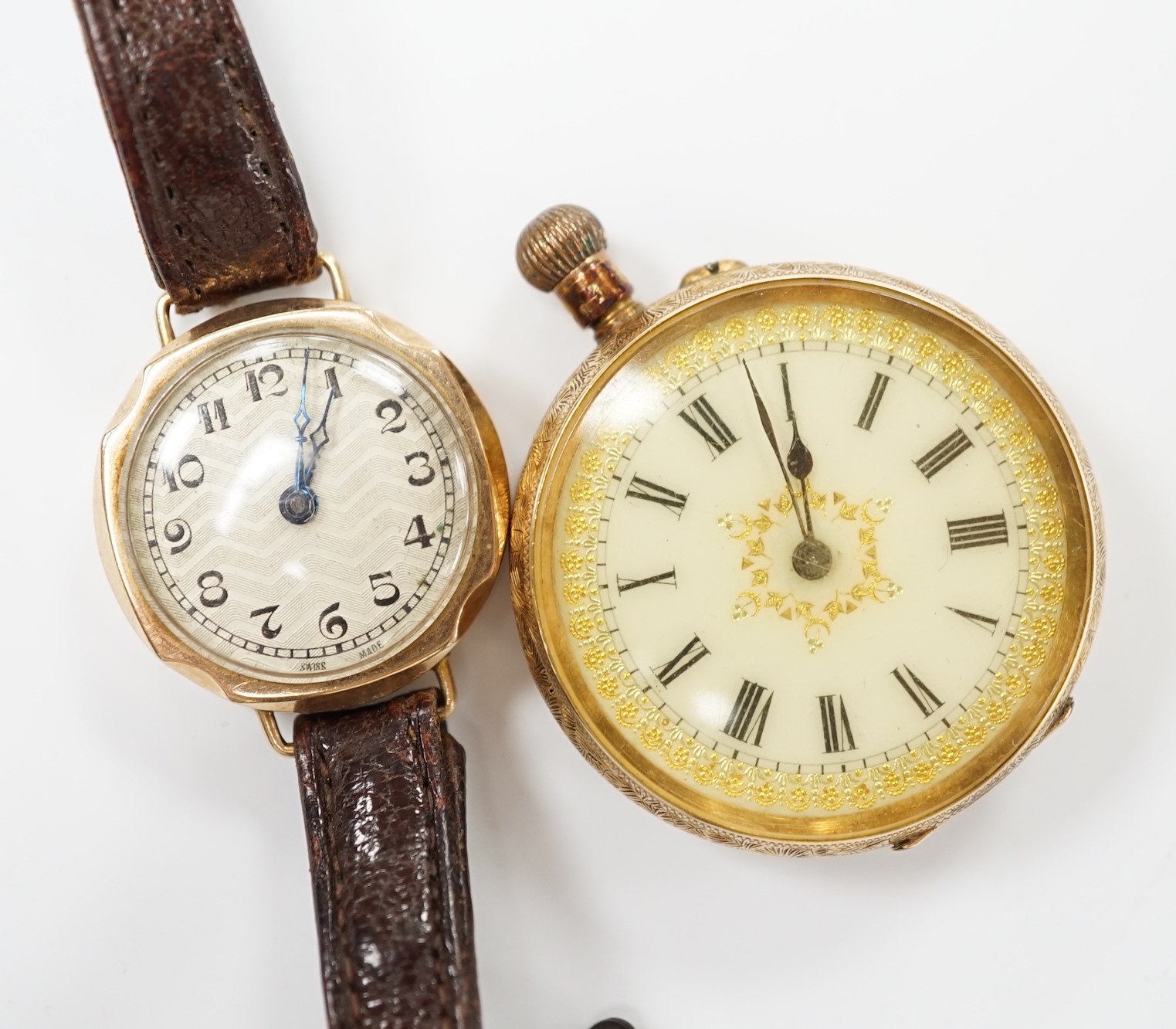 A 14k open faced keyless fob watch, with Roman dial, gross weight 31.7 grams and a lady's 9ct gold manual wind wrist watch (lacking winding crown), on a leather strap.